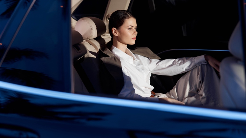 Private chauffeur at night in front of a Mercedes