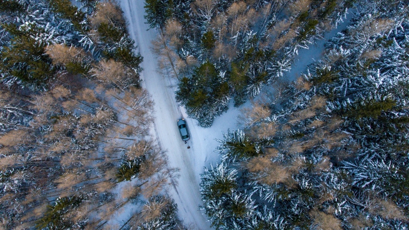 Chauffeur-driven van on a snowy mountain road