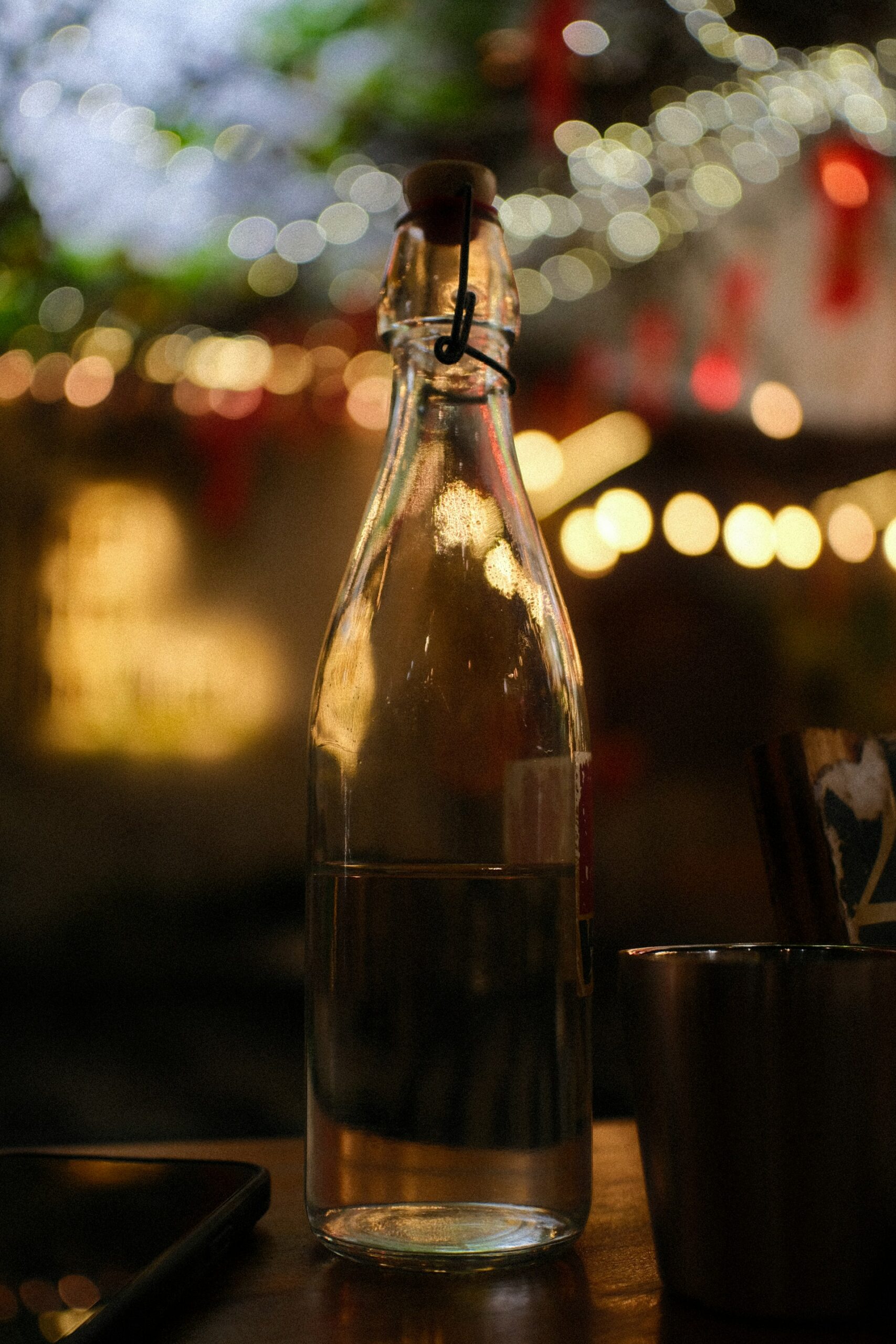 Glass water bottle with a swing-top stopper
